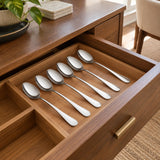 Six Decakila stainless steel spoons stored neatly in a dining sideboard cutlery drawer.