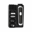 Decakila KMHR017W black-and-silver 5-in-1 rechargeable grooming kit with interchangeable heads, guide combs, and cleaning brush in its storage tray.