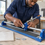 African American tile installer fitting the Wadfow replacement scoring wheel onto a 600mm manual tile cutter