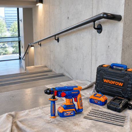 Completed concrete stair handrail with the Wadfow cordless rotary hammer kit resting nearby after installation work
