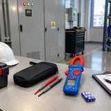 Wadfow WDM8802 clamp meter beside a closed electrical cabinet in an orderly facility maintenance area