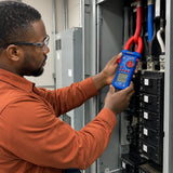 Electrician using a Wadfow WDM8802 clamp meter around an insulated conductor in a commercial electrical room