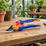 Wadfow pruning shear resting closed on an organised greenhouse potting bench