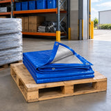 Folded Wadfow blue polyethylene tarp stored on a pallet in an organised covered materials-loading area