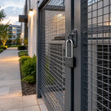 Locked commercial service enclosure with a Wadfow long-shackle padlock in a tidy courtyard