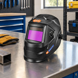 Wadfow auto-darkening welding helmet resting on a clean fabrication workshop bench beside organised PPE storage
