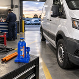 Serviced commercial vehicle ready in a clean maintenance bay with the lowered Wadfow WHJ1510 bottle jack parked nearby