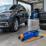 Serviced vehicle ready to leave beside the parked Wadfow WHJ2531 floor jack in a clean fleet-maintenance bay.