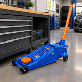 Wadfow WHJ2535 low-profile floor jack parked in an organised contemporary automotive workshop.