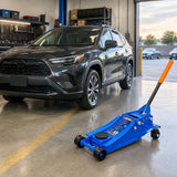 Compatible vehicle ready to leave a service bay with the inactive Wadfow WHJ2541 floor jack parked nearby