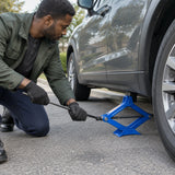 African American driver manually raises a compatible car with a Wadfow WHJ4515 scissor jack during a roadside wheel change
