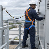 African American maintenance technician wearing a Wadfow WSQ1515 harness while inspecting an elevated service platform