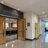 Completed university corridor maintenance with a closed high access panel and stored Wadfow WLD4939 ladder