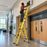Facilities technician using a Wadfow WLD4939 extension ladder to reach a high service access panel in a university corridor