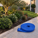 Freshly watered landscaped border with the drained Wadfow blue lay-flat hose coiled nearby