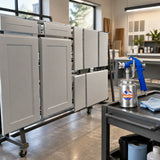 Evenly base-coated furniture panels ready for finishing with a Wadfow WGA1515 spray gun resting nearby