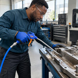 Technician using a Wadfow WGA4611 air blow gun to clear debris from a recessed metal machine component