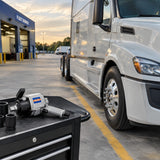 Serviced commercial truck ready for dispatch with a Wadfow pneumatic impact wrench resting on a nearby tool cart