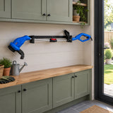 Wadfow WXM3512 electric grass trimmer resting in a tidy covered garden utility area