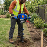 African American grounds worker using a Wadfow 62cc earth auger power head to bore a post hole in garden soil