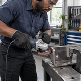 African American metal-fabrication technician using a Wadfow 115mm flap disc to deburr a clamped steel bracket