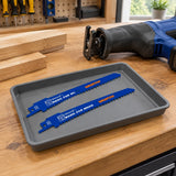 Wadfow WJT611D wood saw blades stored beside a compatible reciprocating saw on an organised carpentry workbench.