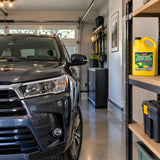 Maintained vehicle ready in a contemporary garage with a capped ABRO green coolant bottle stored nearby