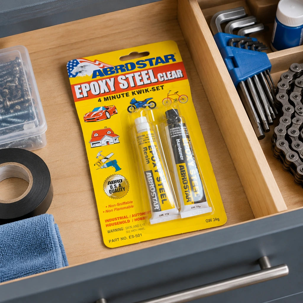 Sealed ABROSTAR ES-501 clear epoxy blister pack stored in an organised home repair drawer