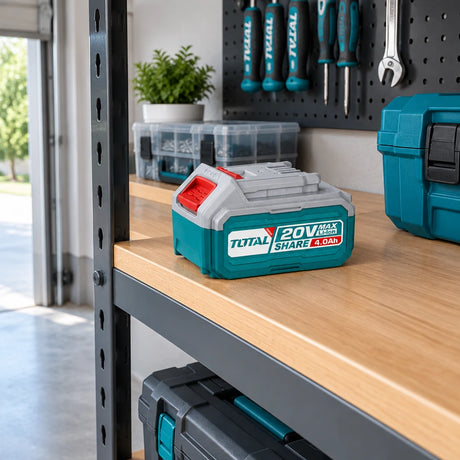 Total 20V spare battery stored on an organised home garage tool shelf