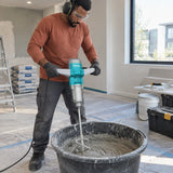 African American renovation worker using the Total TD716008 electric mixer to blend compound in a tub