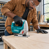 African American cabinetmaker guiding a Total TS2081006 jigsaw through a curved plywood cabinet panel