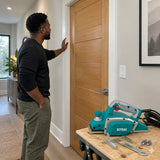 Finished timber interior door fitting with the inactive Total electric planer nearby in a contemporary hallway