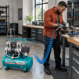 African American workshop technician using the Total 15L air compressor to supply a compatible pneumatic tool