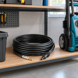 Total TGTPCH751 pipe-cleaning hose stored beside a compatible pressure washer in a clean utility room