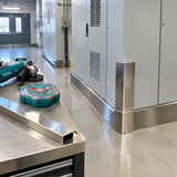 Finished stainless-steel protective trim with the Total TAC1015115 disc set and inactive cutting machine nearby