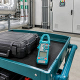 Total TMT766001 AC clamp meter resting on a maintenance cart in a clean commercial plant room
