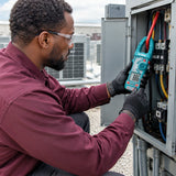 HVAC technician using the Total TMT766001 AC clamp meter around an insulated conductor in a plant room