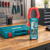 Total TMT7610002 clamp meter resting on an organised electrical service workshop bench