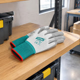 Total XL PU-coated work gloves resting on a PPE shelf in an organised warehouse receiving area