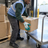 African American receiving worker wearing Total TSP13103 gloves and moving a sealed carton onto a platform trolley.