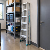 Closed Total THLAD01071 double-sided aluminium ladder parked in an organised retail backroom storage area.