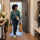 African American resident carries groceries into a contemporary home after entering through the Supply Master K9-6085 smart lock