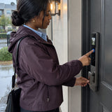 African American resident uses the Supply Master K9-6085 fingerprint sensor to enter through a covered home entrance