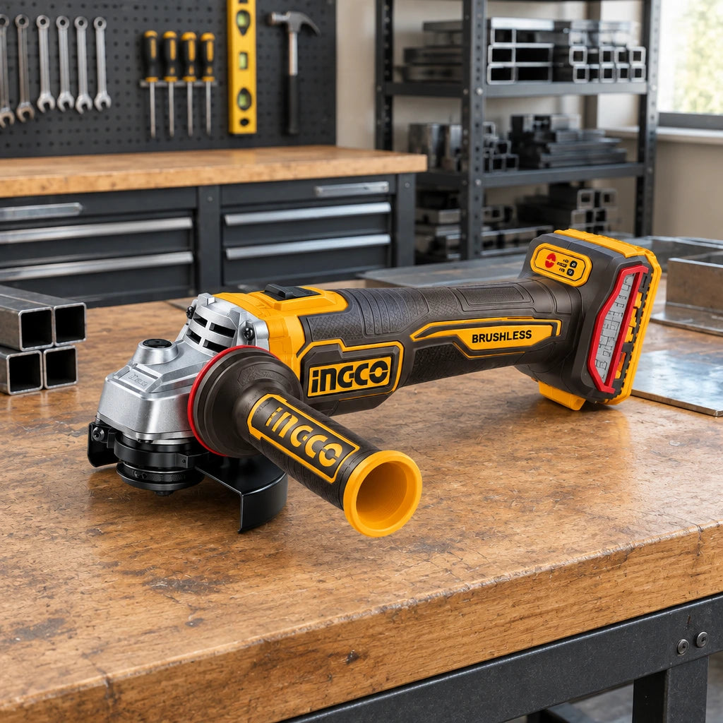 Ingco cordless angle grinder resting on an organized metal fabrication workbench