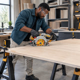 African American cabinet installer using an Ingco cordless circular saw to make a straight cut in a secured plywood shelf panel