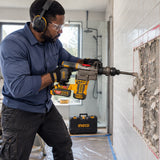 African American renovation specialist using the Ingco cordless demolition breaker to remove a marked tiled wall section