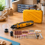 Ingco CMGLI0801 cordless mini grinder resting beside its storage case on an organised home craft workbench.