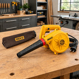 Ingco AB4068 electric blower resting on a cabinetmaking workshop bench with its supplied dust bag nearby.