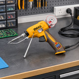 Ingco SI036732 soldering gun resting inactive on an organised electronics repair workstation.