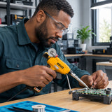 African American electronics technician using the Ingco SI036732 soldering gun to join a prepared low-voltage wire connection.